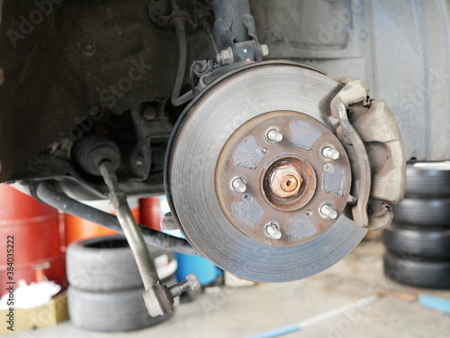 maintenance car disc brake system in garage.