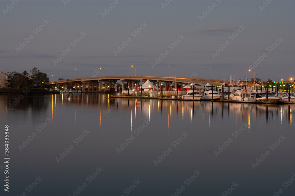 Long exposure of motorboats lining the docks in a marina in Belmar, New Jersey, on a warm autumn evening -05