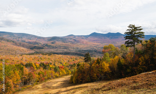 Beautiful mountain view in New Hampshire during Autumn when the leaves are changing orange, yellow, red, and golden.