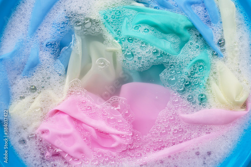 Color clothes soak in powder detergent water dissolution. Laundry concept
