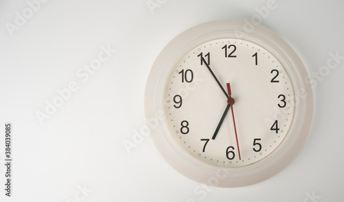 White clock isolated on white background Showtime 06.55 am, Time concept.