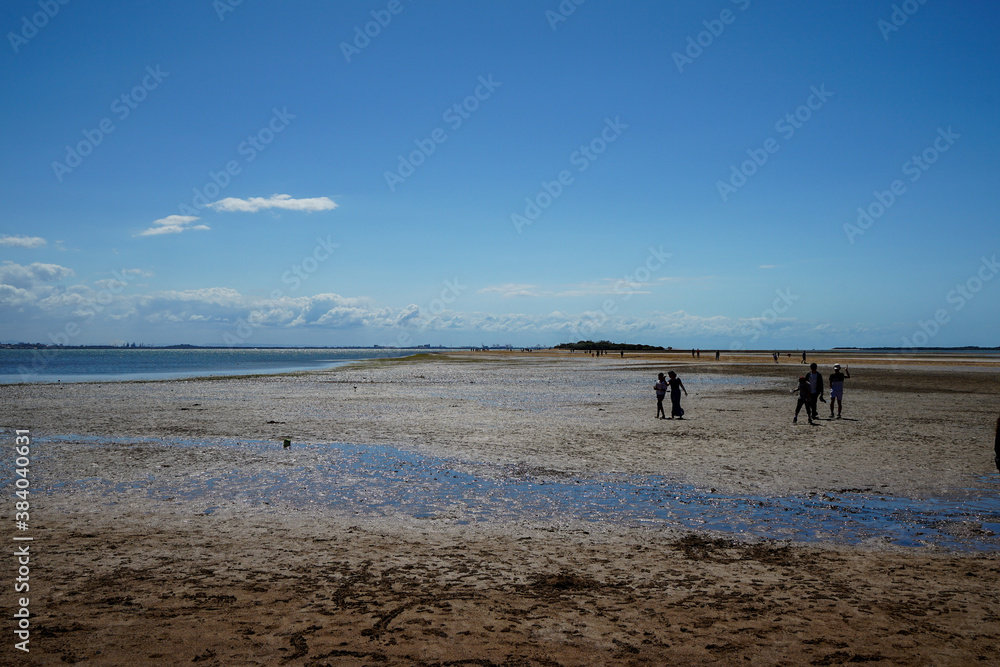 people walking on the beach in the late afternoon at Wellington Point, Queensland