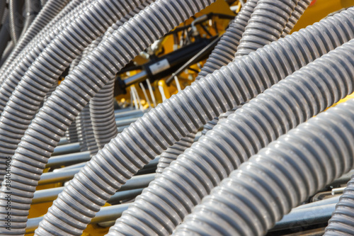 Plastic corrugated pipes in agricultural or industrial machinery. Part of hydraulic or pneumatic equipments © ratmaner