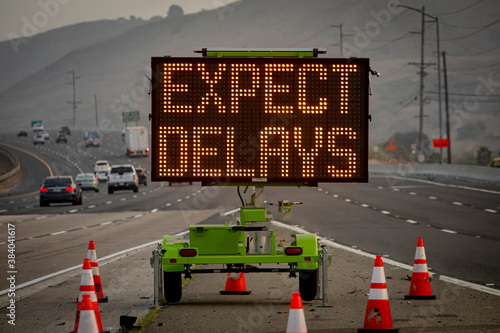 Electronic Road Sign stating Expect Delays with traffic photo