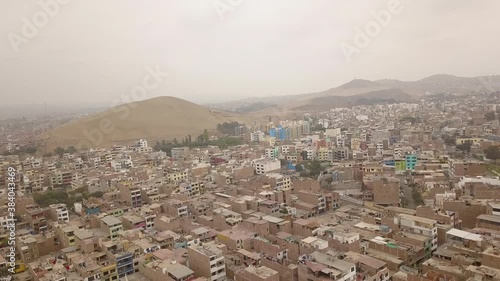 aerial view of houses built in what was once an arid area with hills in the district of santiago de surco, lima, peru. photo