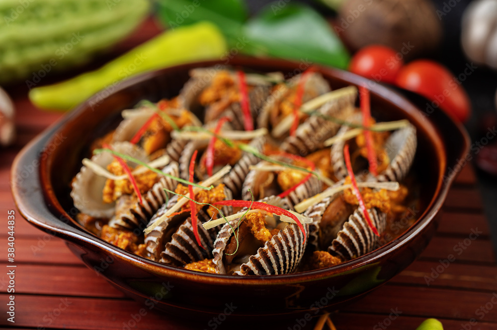 Cockles sauteed in curry powder with bell peppers and tomatoes. Cockles sauteed in curry powder with bell peppers and tomatoes.