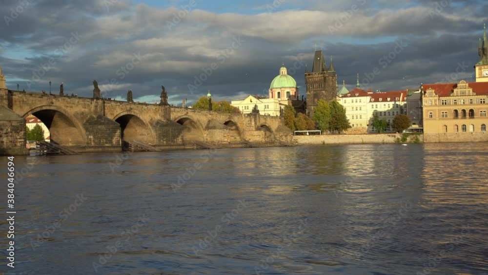 panoramic shot of the movement of the Charles Bridge and the flowing Vltava river in the center of the city of Prague in the Czech Republic panoramic shot of the movement of the Charles Bridge and the flowing Vltava river in the center of the city of Prague in the Czech Republic