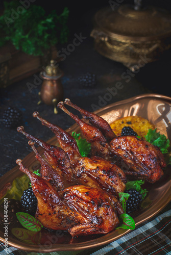 Schilderij op canvas Roasted quails with oranges and berries