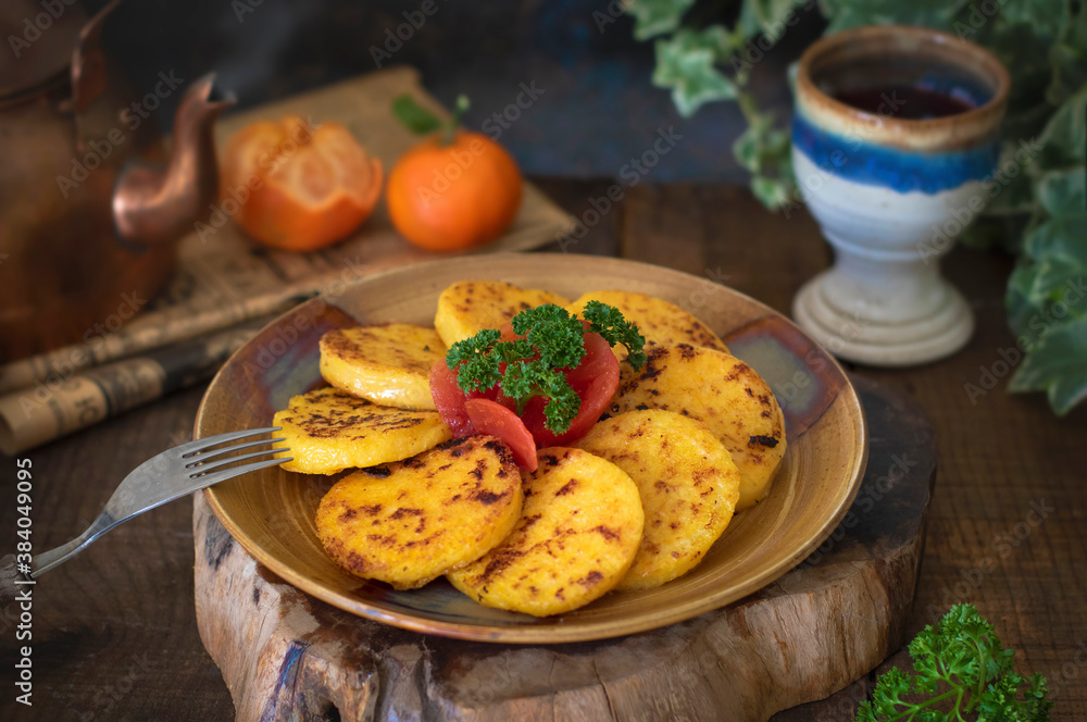 Hot fried polenta served with tomatoes and herbs Hot fried polenta served with tomatoes and herbs
