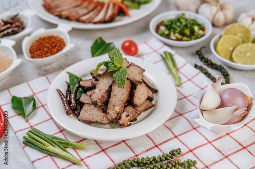 Grilled Liver Slices with sliced ​​lime, carrots, chili, spring onions, and mint.