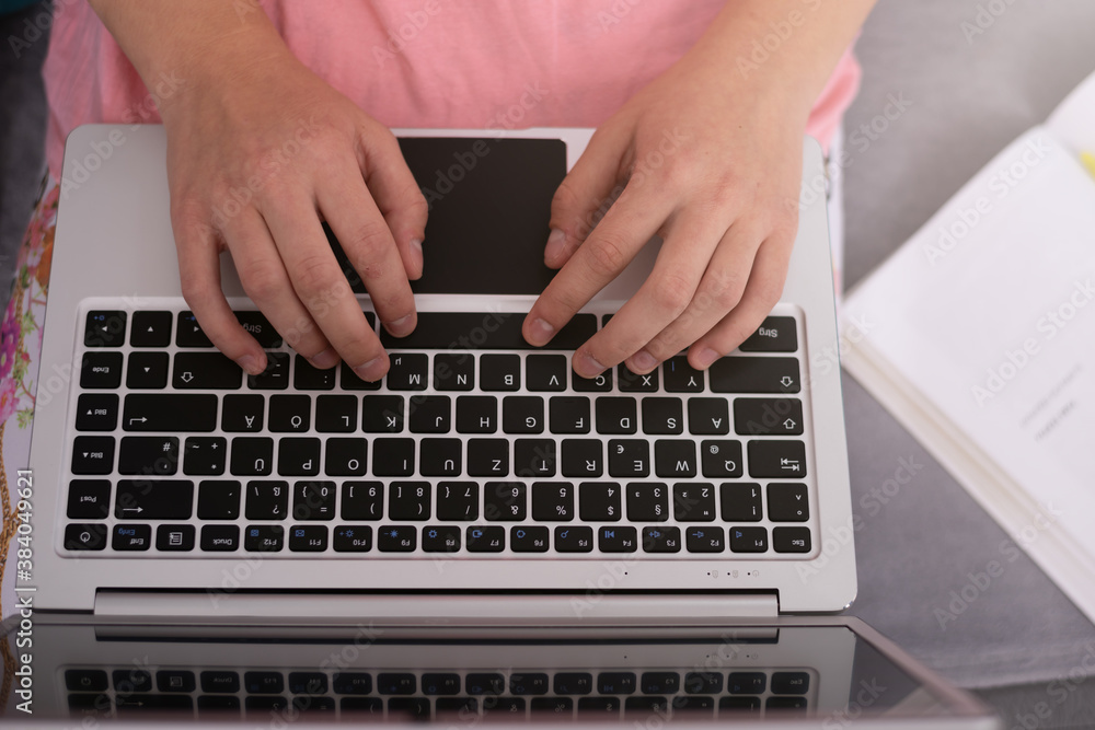 Fototapeta premium Teenage girl with laptop having online school class at home. Home Schooling. Learning from home in coronavirus times.