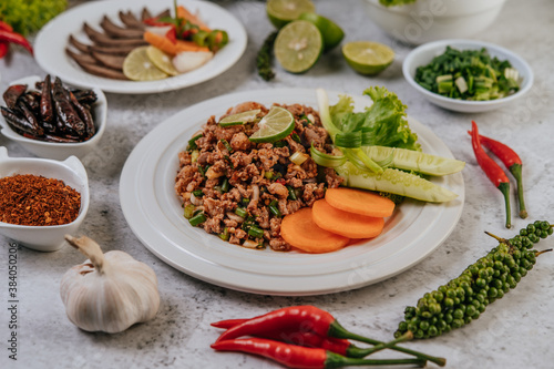Pork Larb with carrot, cucumber, lime, spring onion, chili, freshly ground pepper, and lettuce