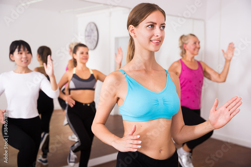 Women dancing aerobics at lesson in the dance class. High quality photo © JackF
