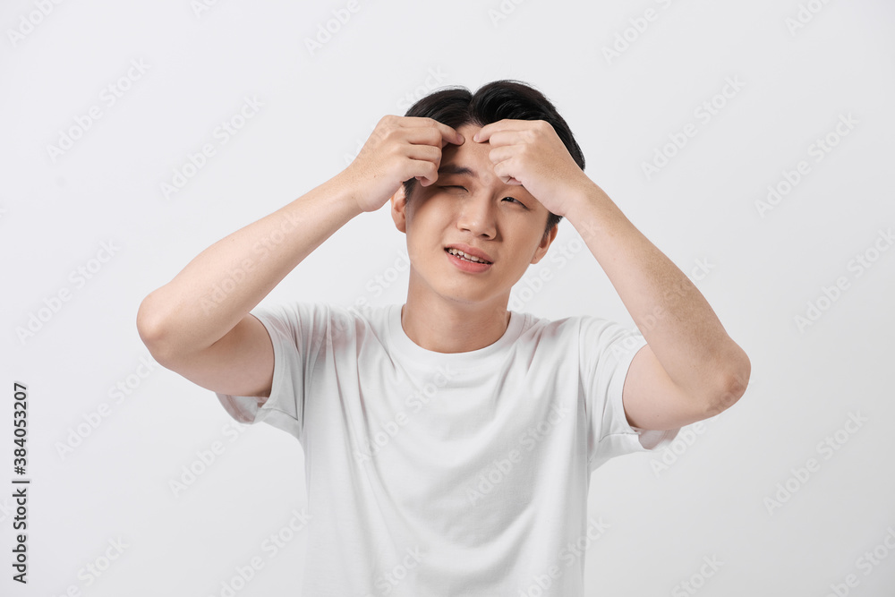 young man squeezing a pimple, men's skincare concept young man squeezing a pimple, men's skincare concept