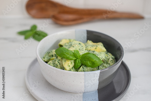 Italian Tortellini with spinach and basil on a table
