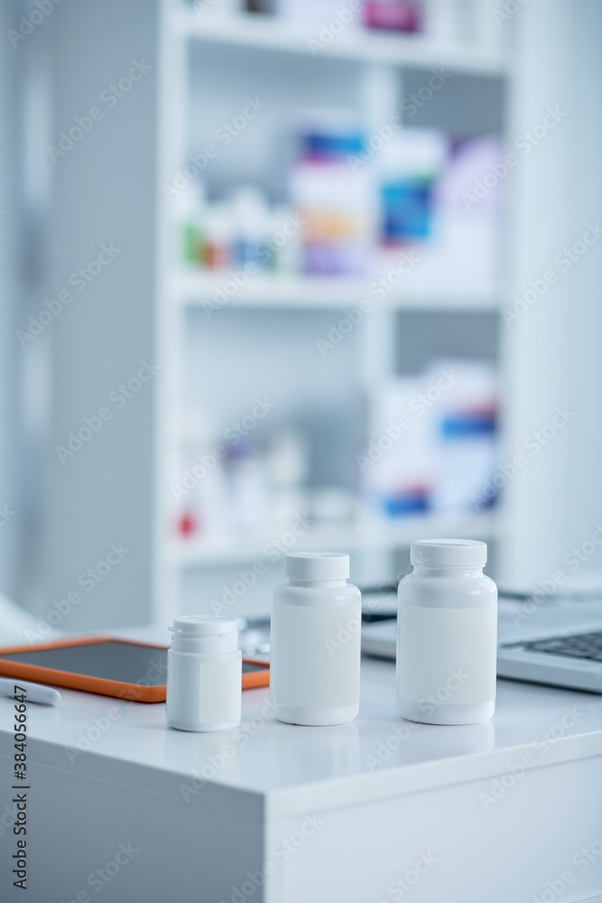 White bottles with medicine on the table White bottles with medicine on the table