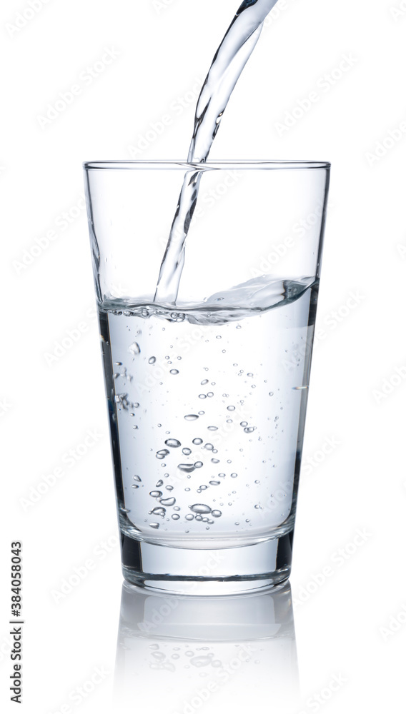 Pour water into a glass placed on a white background. Pour water into a glass placed on a white background.