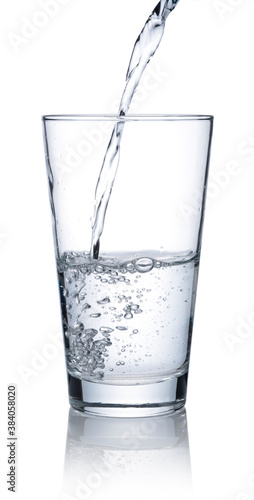 Pour water into a glass placed on a white background.