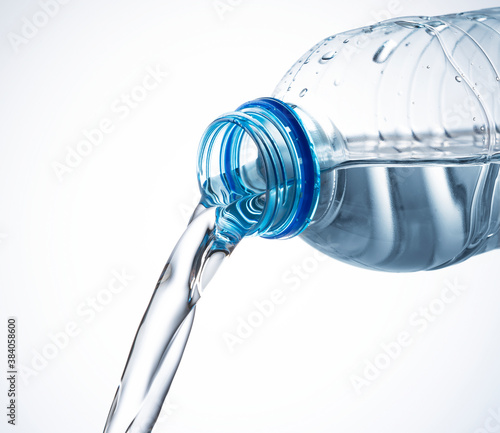 Water from a plastic bottle on a white background