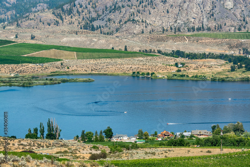 Okanagan valley scenery view with residential area and orchard farm fields
