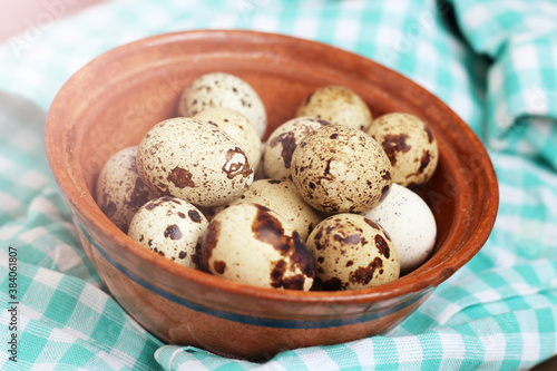 Group of quail eggs on a brown plate, eco food