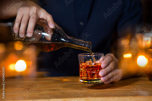 Bartender Serve Whiskey  on wood bar 