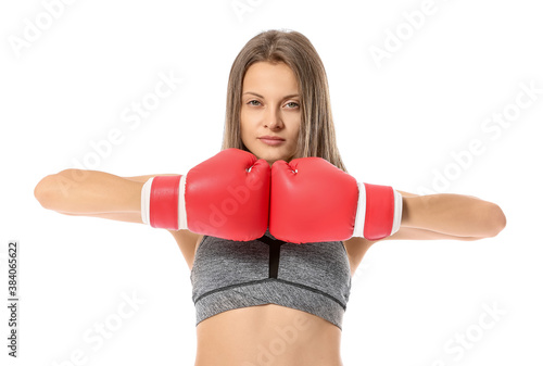 Sporty young woman in boxing gloves on white background © Pixel-Shot