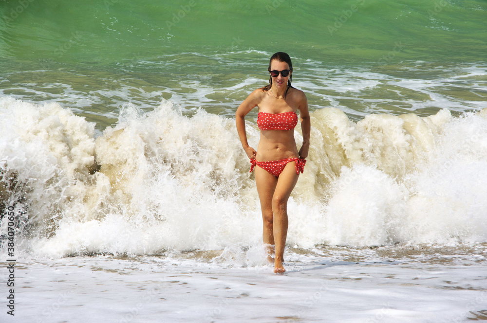 Fototapeta premium Young woman having fun in stormy sea
