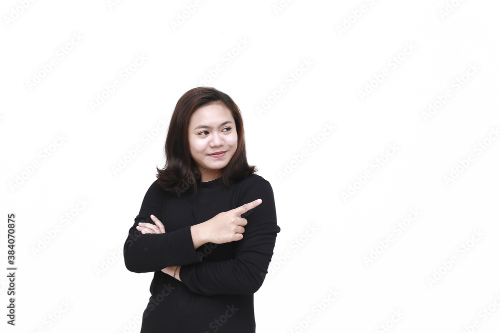 Portrait of Asian young happy woman smiling and pointing to presenting something on her side, with copy space Portrait of Asian young happy woman smiling and pointing to presenting something on her side, with copy space