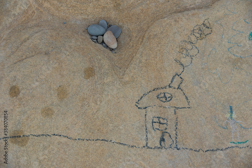 Children's drawing on a stone. Drawing, beach, kids, play, creativity.