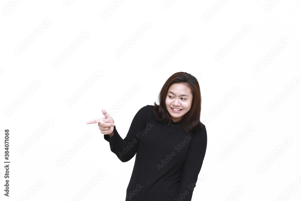 Portrait of Asian young happy woman smiling and pointing to presenting something on her side, with copy space Portrait of Asian young happy woman smiling and pointing to presenting something on her side, with copy space