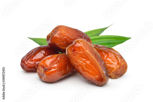 Dried Date palm fruits with green leaves isolate on white background. photo