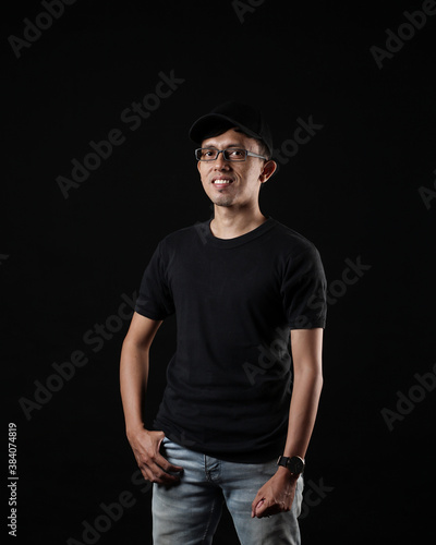 Young men in empty black T-shirts, stylish and posing like famous T-shirt models. Men's t-shirt template and mockup design for print. photo shoot models isolated black background.
