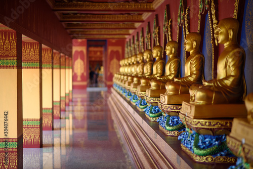 The scenery of the row of buddhas inside Wat Bang Thong temple (golden pagoda) at Krabi province, Thailand.