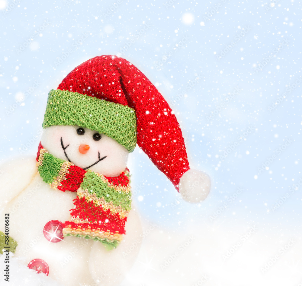 Snowman toy on the bokeh winter background . Christmas background. Copy space for text