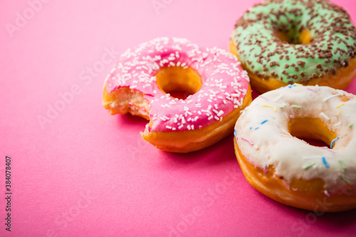 Studio shot of a colorful donuts on pink background.