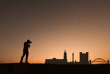 man next to newcastle city skyline silhouette