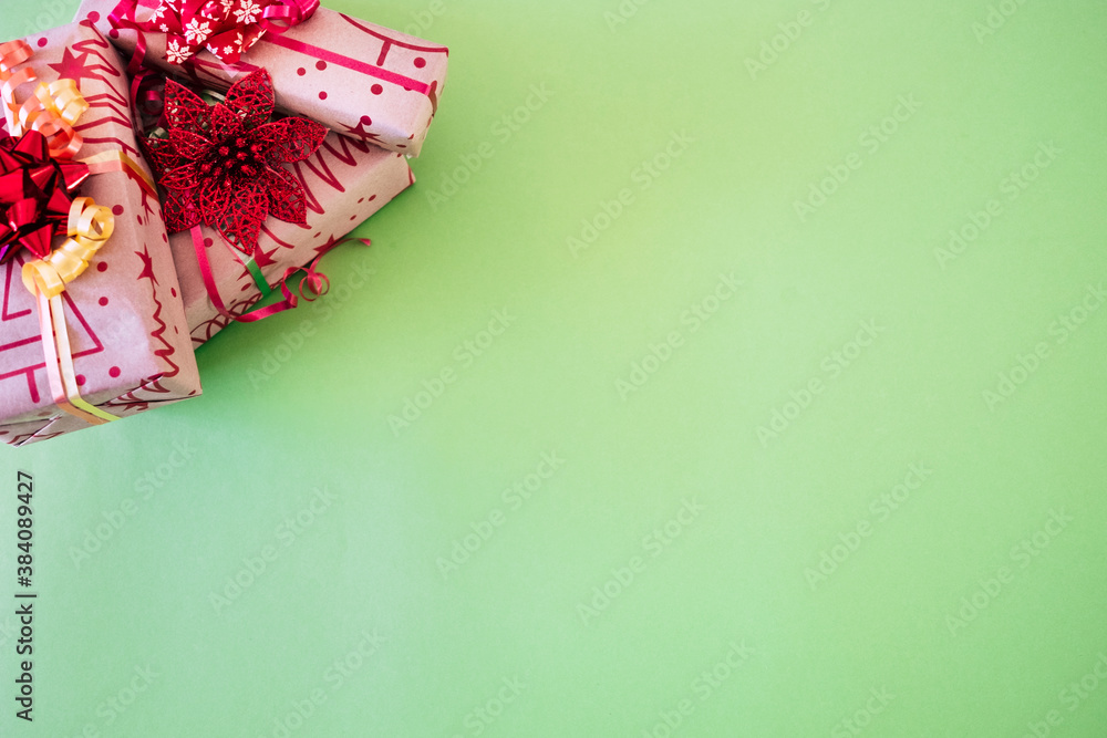 Christmas presents and ornaments on a green background. Copy space