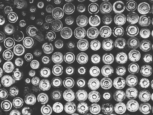 Old used batteries group. Top view background texture. Black and white