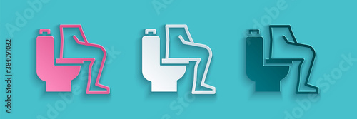 Paper cut Men sitting on the toilet and Constipation are experiencing severe abdominal pain icon isolated on blue background. Paper art style. Vector.