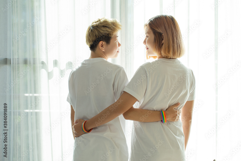 Fototapeta premium Happy lesbian couples embrace each other in love.symbol of the struggle for homosexual rights, concept of sexual freedom and racial diversity