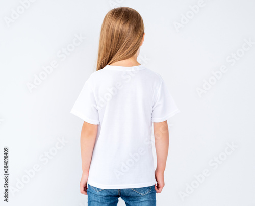 Photography little girl in brand new white blank t-shirt on white background with copy space