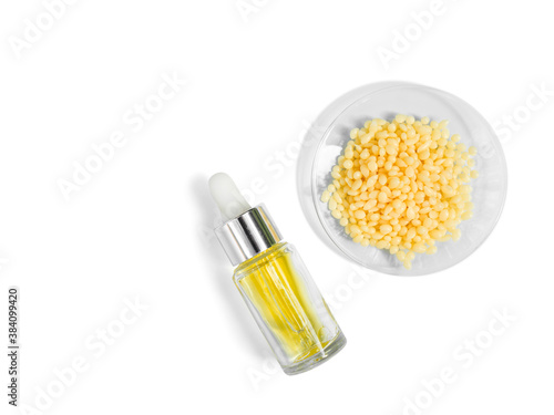 Candelilla Wax SP-75. Chemical ingredient for Cosmetics & Toiletries product. Yellow cosmetic color (oil). Chemicals for beauty care on a white background. (Top View) photo