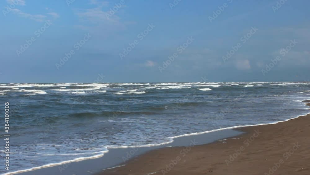 The waves of the Adriatic Sea roll onto the sandy beach. Italy. Rimini The waves of the Adriatic Sea roll onto the sandy beach. Italy. Rimini