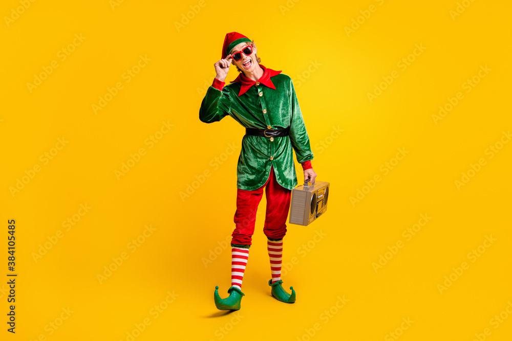 Full length body size view of his he nice attractive skinny glad cheerful cheery funny guy elf carrying player having fun isolated over bright vivid shine vibrant yellow color background Full length body size view of his he nice attractive skinny glad cheerful cheery funny guy elf carrying player having fun isolated over bright vivid shine vibrant yellow color background