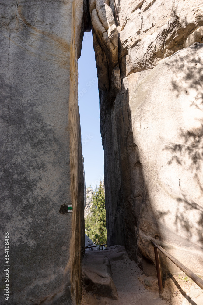 Crevice in the rock. Narrow path through the majestic sandstone rock walls. Adrspach rock city, Czech Republic, Europe Crevice in the rock. Narrow path through the majestic sandstone rock walls. Adrspach rock city, Czech Republic, Europe