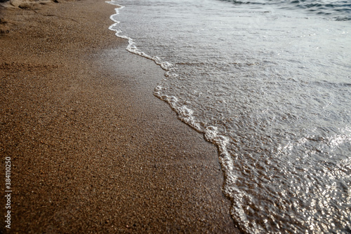 Wave on the sand beach background.