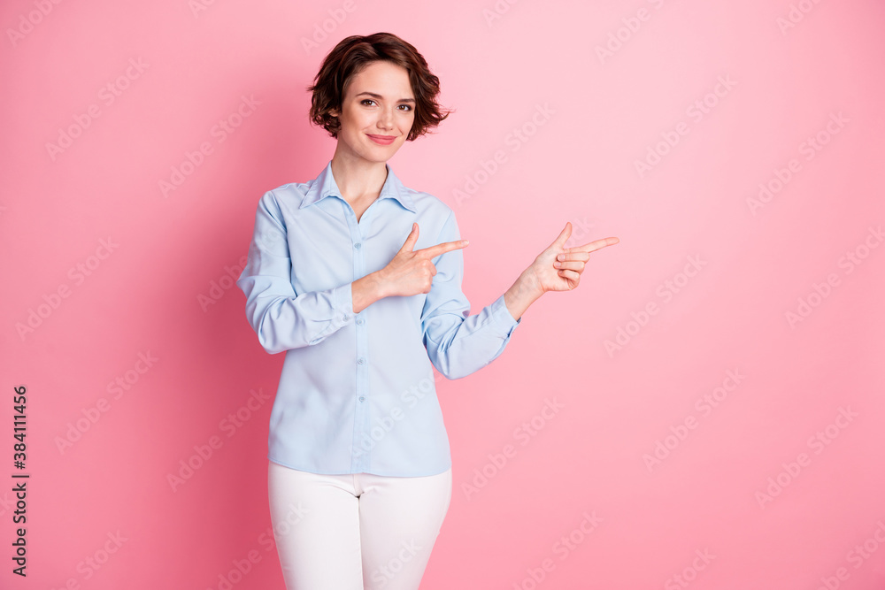 Photo of attractive charming pretty lady direct fingers side empty space show sale discount banner shopper wear blue office shirt white pants isolated pink pastel color background Photo of attractive charming pretty lady direct fingers side empty space show sale discount banner shopper wear blue office shirt white pants isolated pink pastel color background