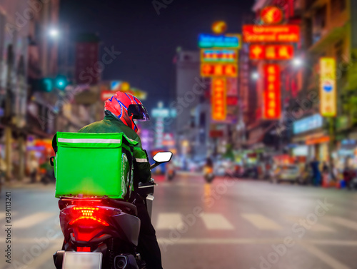 Food delivery drivers are driving deliveries to customers who ordered online at night at Street Food in Chinatown, Thailand.