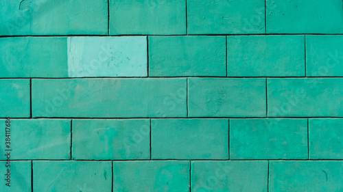 Brick wall is painted mint green color